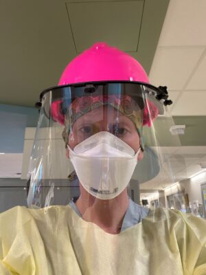 ICU nurse, Catherine Dembrow, takes a selfie in her PPE uniform.