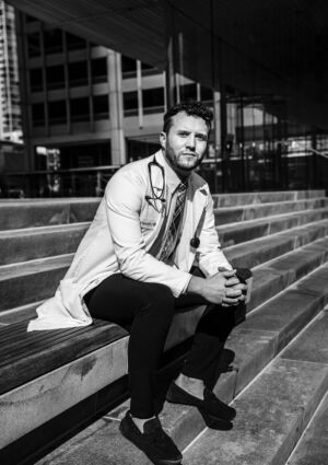 Anesthesiologist Cory Deburghgraeve, who is 33-years-old, poses in front of the University of Illinois at Chicago Hospital.