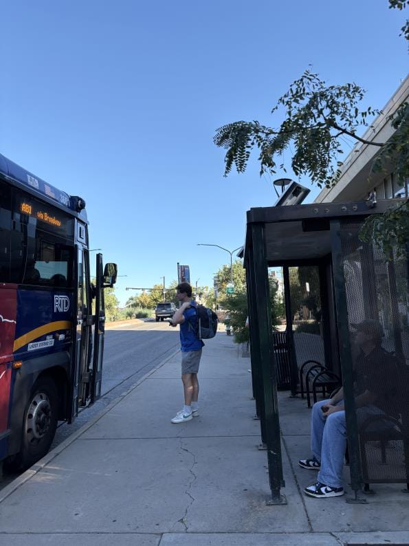 CU student Ryan Noyse waits at an RTD bus stop in Boulder on Sept. 10, 2026. (Photo by Gwen Strickland)