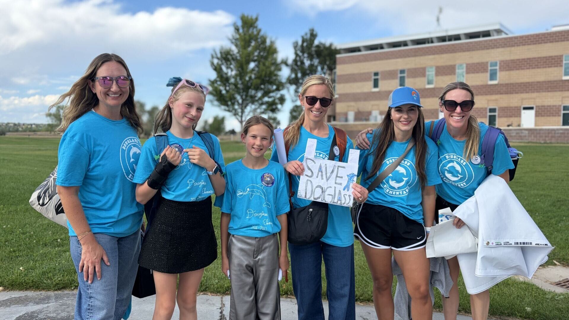Douglass Elementary parents Elaina Shively, Skyla Enyart, Emery Shively, Savannah Ross, Olivia Hinds and Valerie Enyart (from left to right) pose outside of Monarch High School in Louisville, Colorado, on Sept. 8, 2026. (Photo by Bronte Moore)
