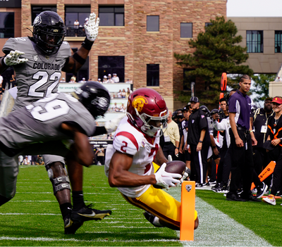 USC wide receiver Brenden Rice dives for the pylon with CU safety Rodrick Ward in pursuit. Rice, the son of Hall of Fame receiver Jerry Rice, caught five passes for 81 yards and scored two touchdowns in USC’s 48-41 win on Saturday. (Photo by Talus Schreiber/Sko Buffs Sports)