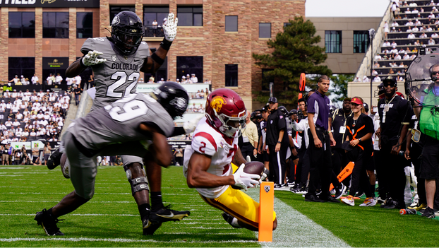 USC wide receiver Brenden Rice dives for the pylon with CU safety Rodrick Ward in pursuit. Rice, the son of Hall of Fame receiver Jerry Rice, caught five passes for 81 yards and scored two touchdowns in USC’s 48-41 win on Saturday. (Photo by Talus Schreiber/Sko Buffs Sports)