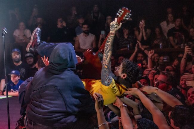 Sueco’s guitarist (James Marino) crowd-surfs while performing a riff. (Katie McDonald/The Bold)