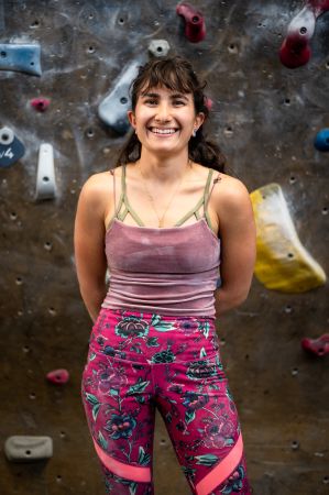 Morgan MDanat poses for a portrait at Movement Boulder on Dec. 1, 2023. MDanat recently started climbing at Cruxing in Color meetups in hopes of finding her climbing community. (Nathan Thompson/CU News Corps)