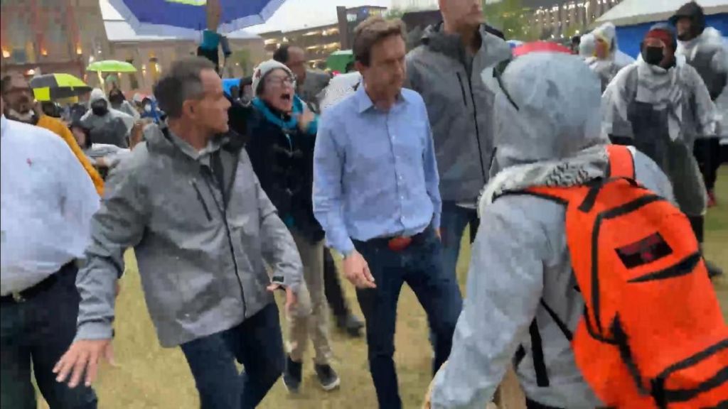 Mayor Mike Johnston, center, is surrounded by protesters in Denver. (CBS, cbsnews.com)