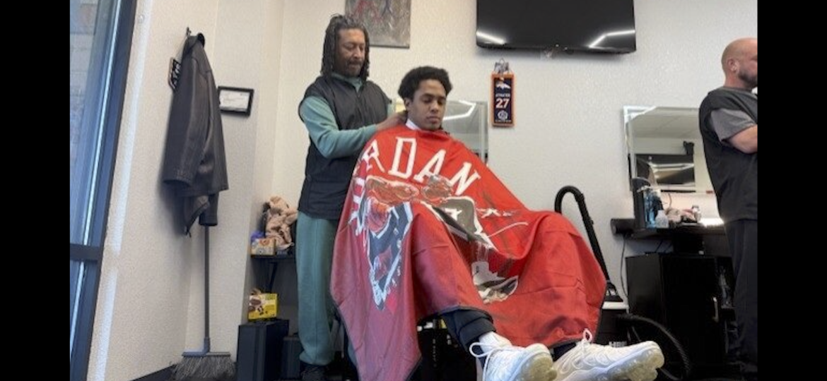 Roey Fisher cuts clients hair