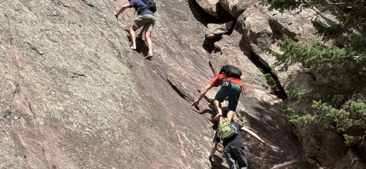 Three climbers scramble on the second Flatiron in Boulder.