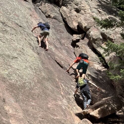Three climbers scramble on the second Flatiron in Boulder.