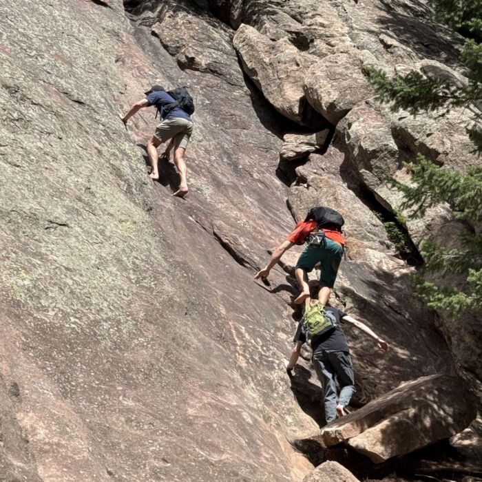 Three climbers scramble on the second Flatiron in Boulder.