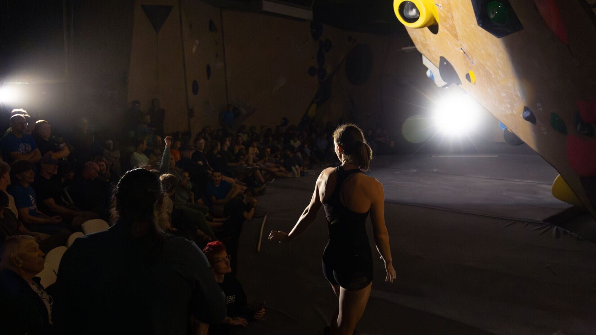 Tate Jennings looks back at the crowd, needing some encouragement to get her to the top of the boulder in front of her at the Heart of Stone climbing competition in Loveland, Colorado, in September 2026. (Photo by Harley Parsons)