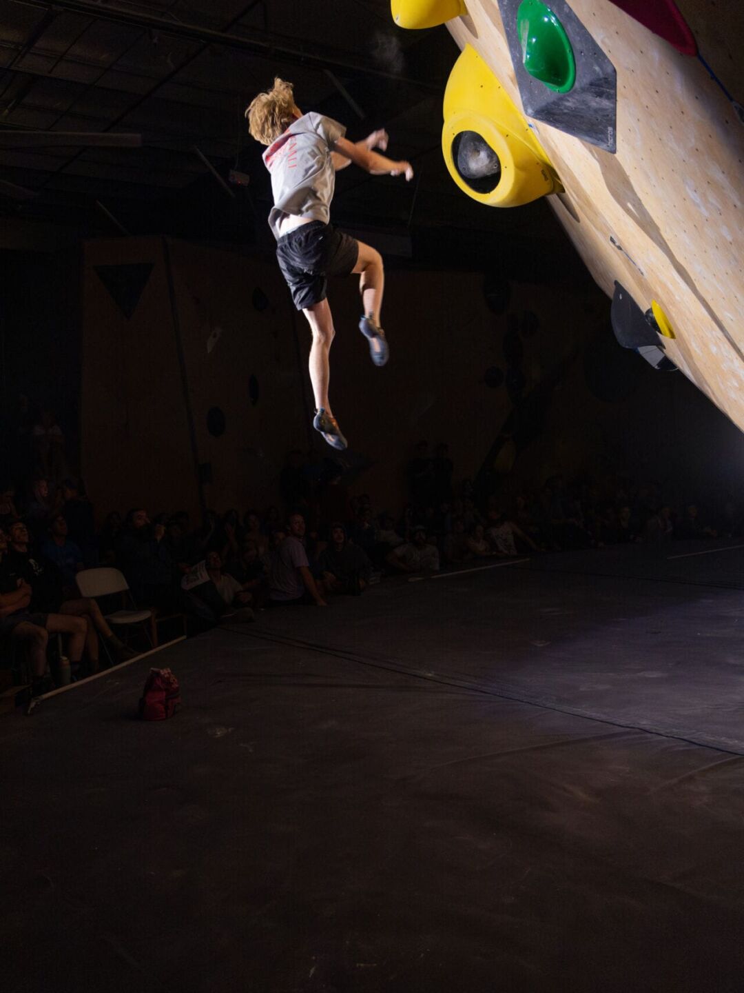 Malachi Donahoe soars through the air as his body weight rips his fingers from the climbing holds at the Heart of Stone climbing competition in Loveland, Colorado, in September 2026. (Photo by Harley Parsons)