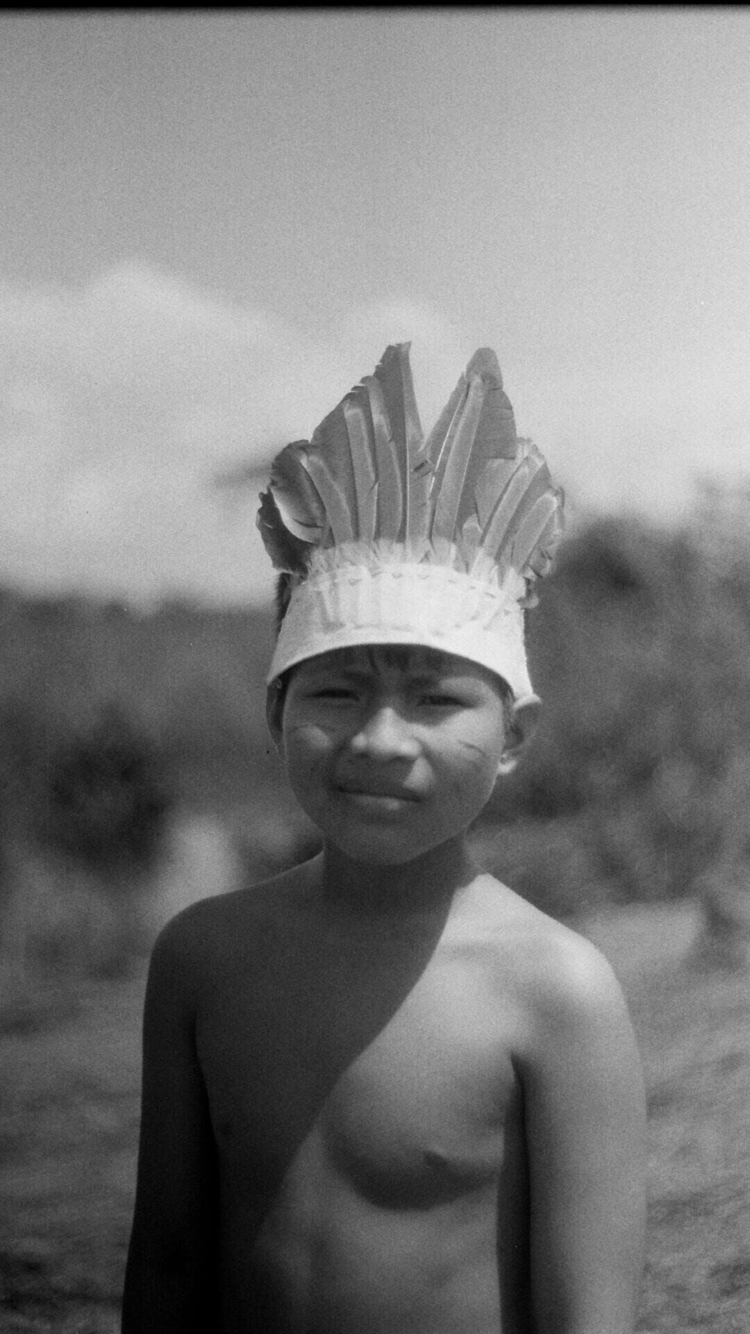 A young boy from the Maloca Bora indigenous community poses for a portrait in a meadow in Iquitos, Peru, on March 1, 2026. (Photo by Will King)