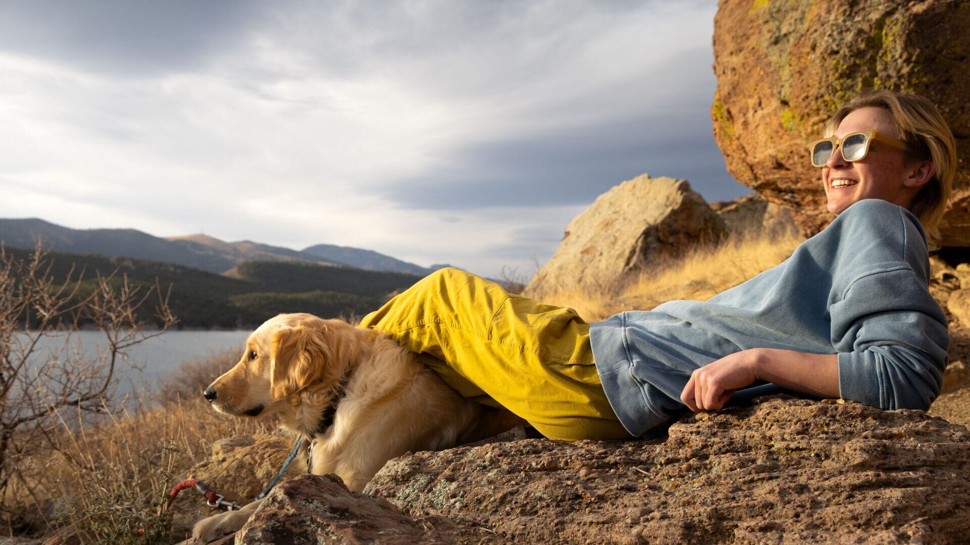Fisher (left) and his owner Tobi Lisse rest after a long day of climbing at Carter Lake in Loveland, Colorado, in March 2026. (Photo by Harley Parsons)